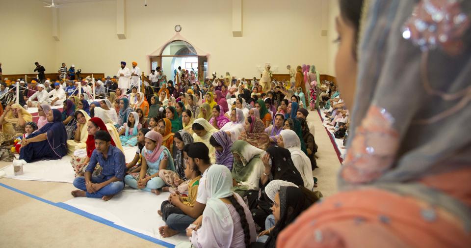 Members of the Sikh temple of Wisconsin pray inside the place of worship Sunday, August, 12, 2012.