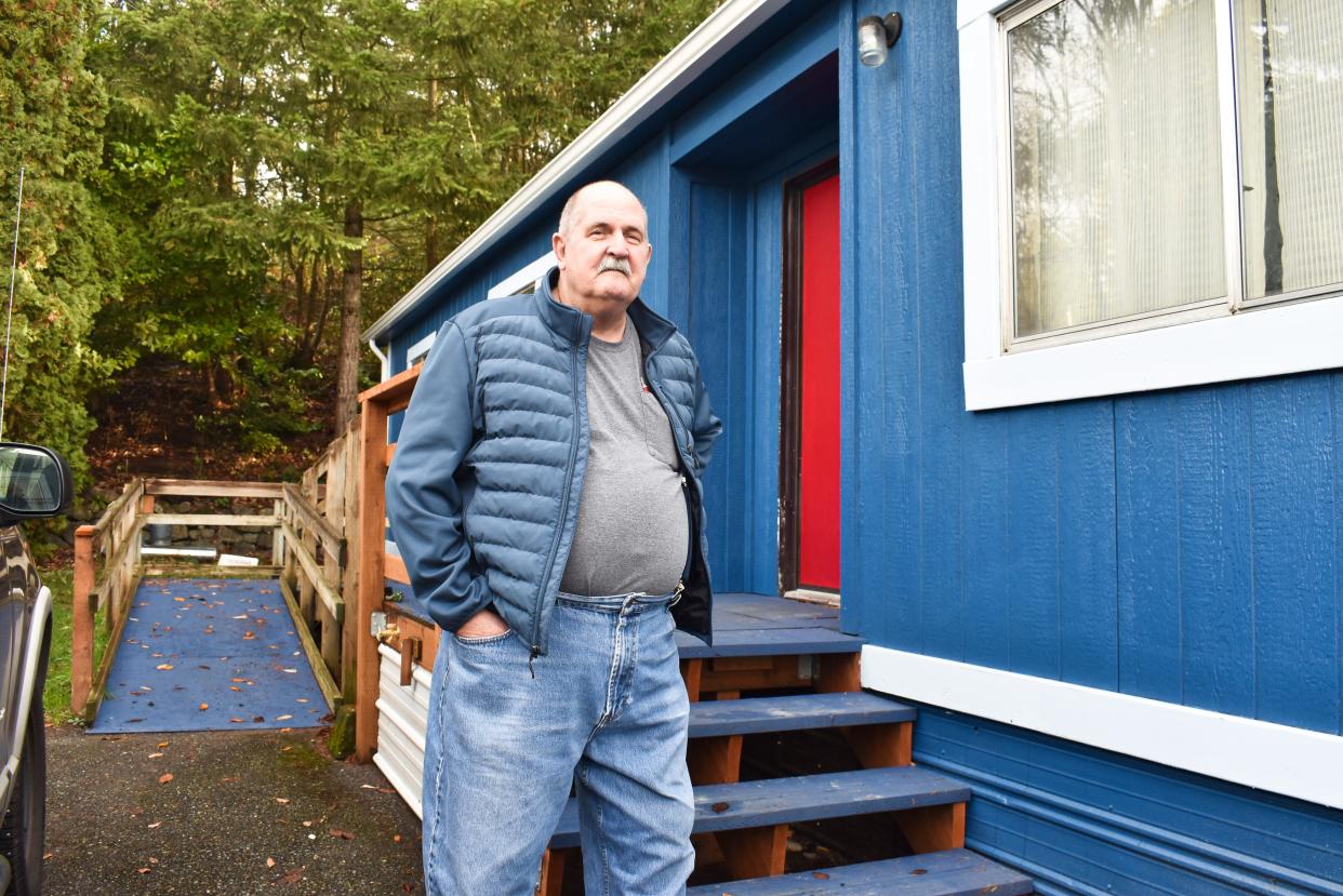 Robert Carlyle stands outside his newly redone mobile home in the Poulsbo Mobile Home Park. Carlyle's unit was one of the first ten homes that the Blue Bills completed before October 7.