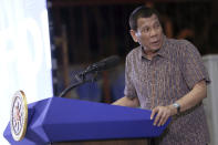 In this Jan. 23, 2020, photo provided by the Malacanang Presidential Photographers Division, Philippine President Rodrigo Duterte delivers his speech at the San Isidro Central School during the distribution of benefits to former rebels in Leyte province, southern Philippines. Duterte has renewed a threat to terminate an accord that allows American forces to train in the country unless Washington restored a visa of a political ally linked to human rights violations. (Karl Norman Alonzo/Malacanang Presidential Photographers Division via AP)