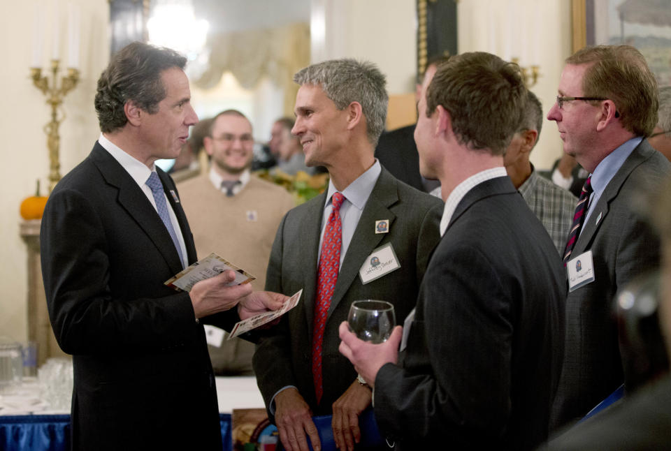 New York Gov. Andrew Cuomo, left, talks to visitors to the Executive Mansion as part of a "Wine, Beer and Spirits Summit" on Wednesday, Oct. 24, 2012, in Albany, N.Y. The aim of the summit is to boost wine production and craft brewers, in part to spur job growth. Visitors to the mansion were able to sample products from around New York state. (AP Photo/Mike Groll)