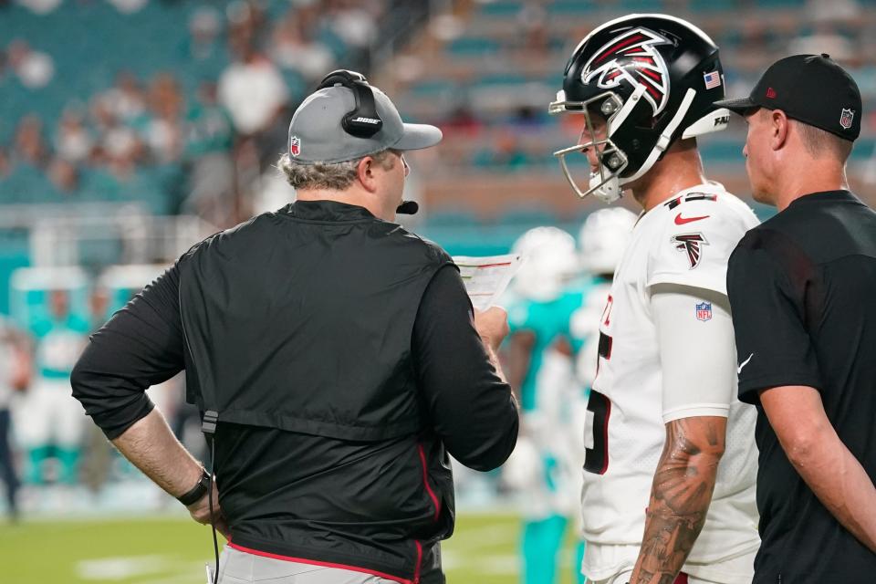 Arthur Smith talks to Falcons quarterback Feleipe Franks, during the first half of a NFL preseason football game against the Miami Dolphins. Franks and Josh Rosen will compete for the backup quarterback position.