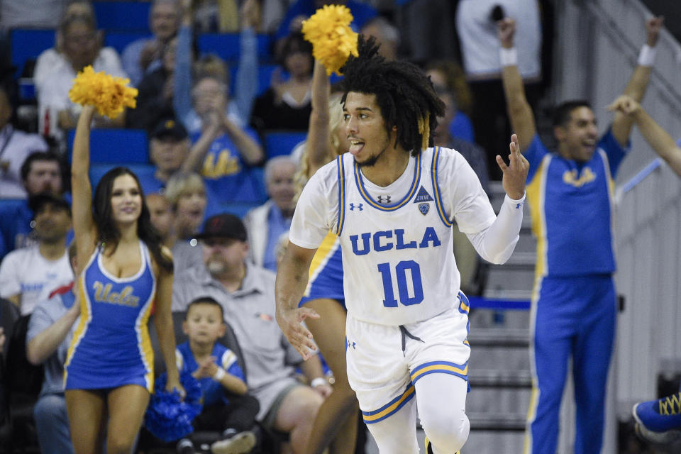 UCLA guard Tyger Campbell celebrates after making a three-point basket during the second half of an NCAA college basketball game against Utah in Los Angeles, Sunday, Feb. 2, 2020. (AP Photo/Kelvin Kuo)
