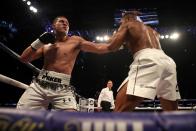 <p>Joseph Parker prepares to throw a right, as Anthony Joshua is on the back foot briefly in round 3 </p>