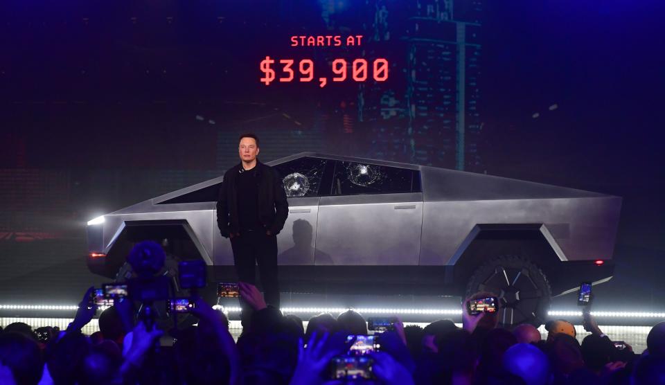 Tesla co-founder and CEO Elon Musk stands in front of the all-electric Tesla's Cybertruck.