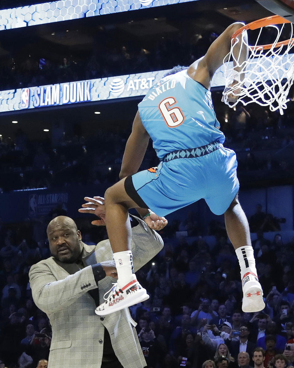 Oklahoma City Thunder Hamidou Diallo leaps over former NBA player Shaquille O'Neal during the NBA All-Star Slam Dunk contest, Saturday, Feb. 16, 2019, in Charlotte, N.C. Diallo won the contest. (AP Photo/Chuck Burton)