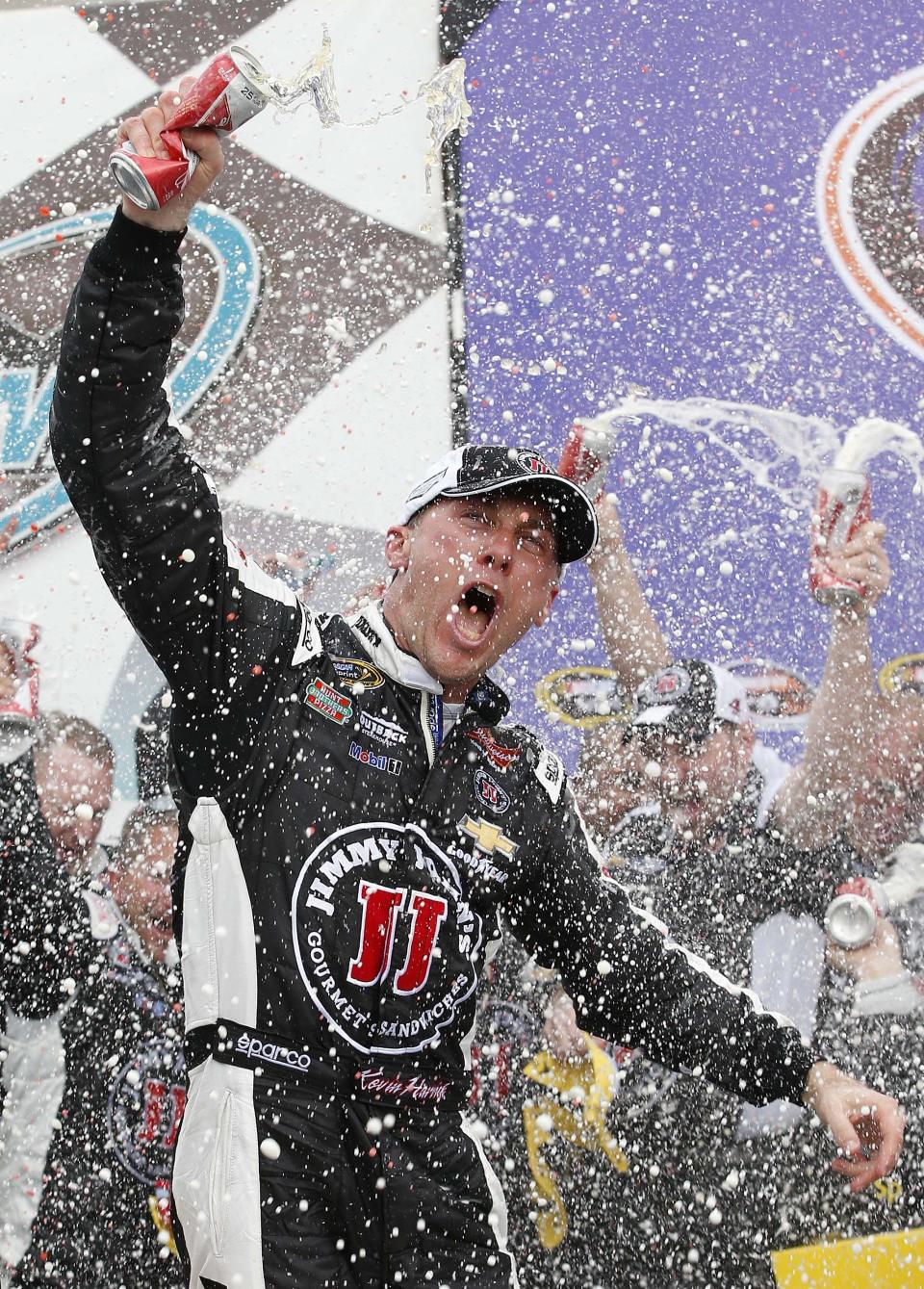 Kevin Harvick celebrates in Victory Lane with his crew after winning the NASCAR Sprint Cup Series auto race Sunday, March 2, 2014, in Avondale, Ariz. (AP Photo/Ross D. Franklin)