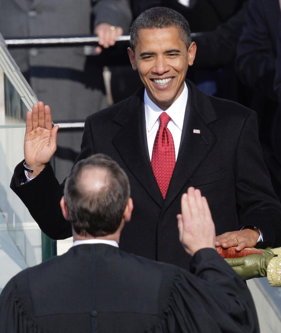 Barack Obama, left, takes the oath of office from Chief Justice John Roberts to become the 44th president of the United States at the U.S. Capitol in Washington, Tuesday, Jan. 20, 2009.