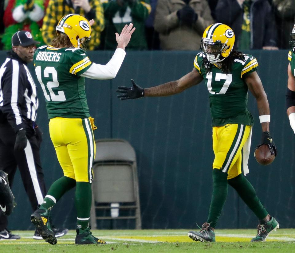 Aaron Rodgers celebrates with wide receiver Davante Adams after scoring a touchdown in the second quarter during their game Dec. 25, 2021, against the Cleveland Browns at Lambeau Field. The touchdown put Adams ahead of the Rodgers-Jordy Nelson connection for most touchdown receptions between a quarterback and receiver in team history.