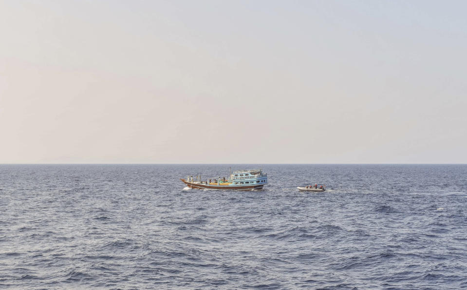 In this photo released by the U.S. Navy, sailors intercept a dhow in the Gulf of Oman on Nov. 8, 2022. The U.S. Navy said Tuesday, Nov. 15, 2022, it found 70 tons of a missile fuel component hidden among bags of fertilizer aboard a ship bound to Yemen from Iran, the first-such seizure in that country's yearslong war as a cease-fire there has broken down. (Lt. Kelly Harris/U.S. Navy, via AP)