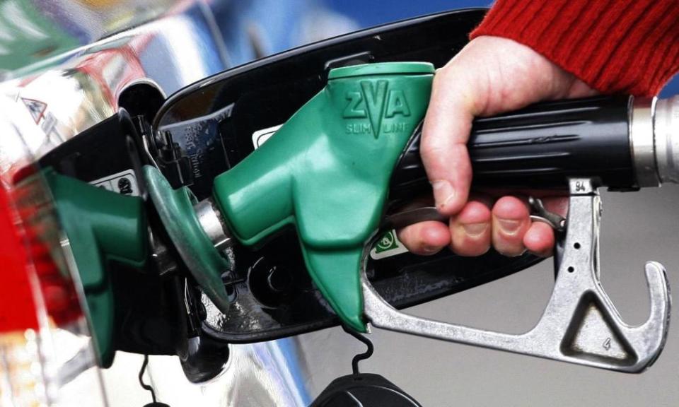 motorist filling car with fuel