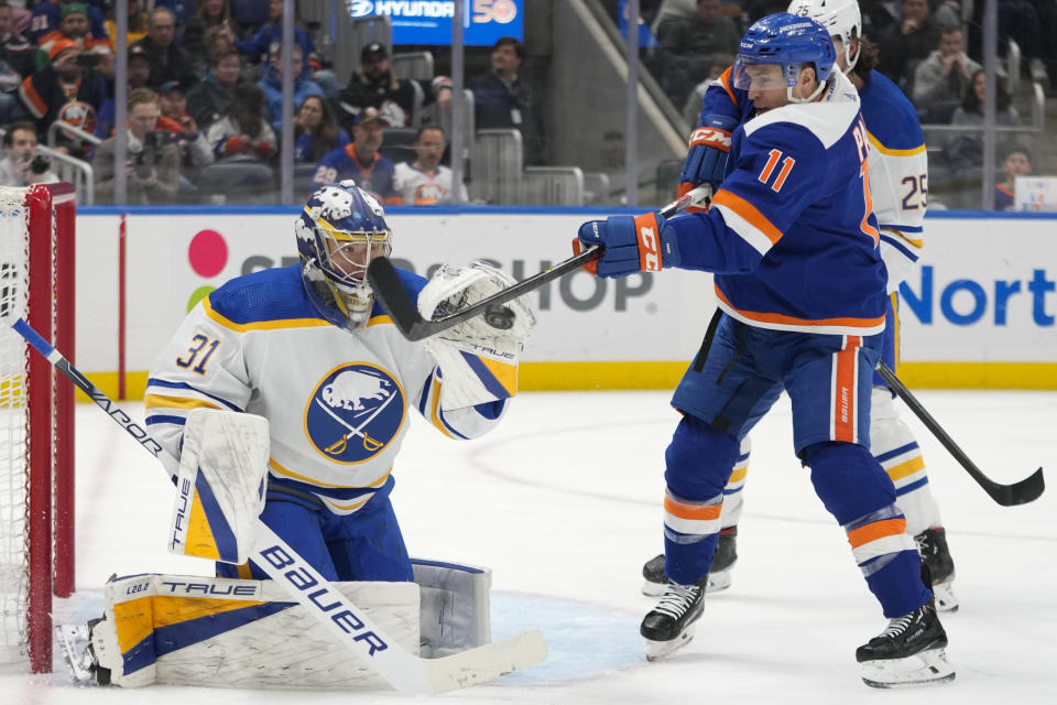 Buffalo Sabres goaltender Eric Comrie (31) makes the save against New York Islanders left wing Zach Parise (11) during the second period of an NHL hockey game, Saturday, March 25, 2023, in Elmont, N.Y. (AP Photo/Mary Altaffer)