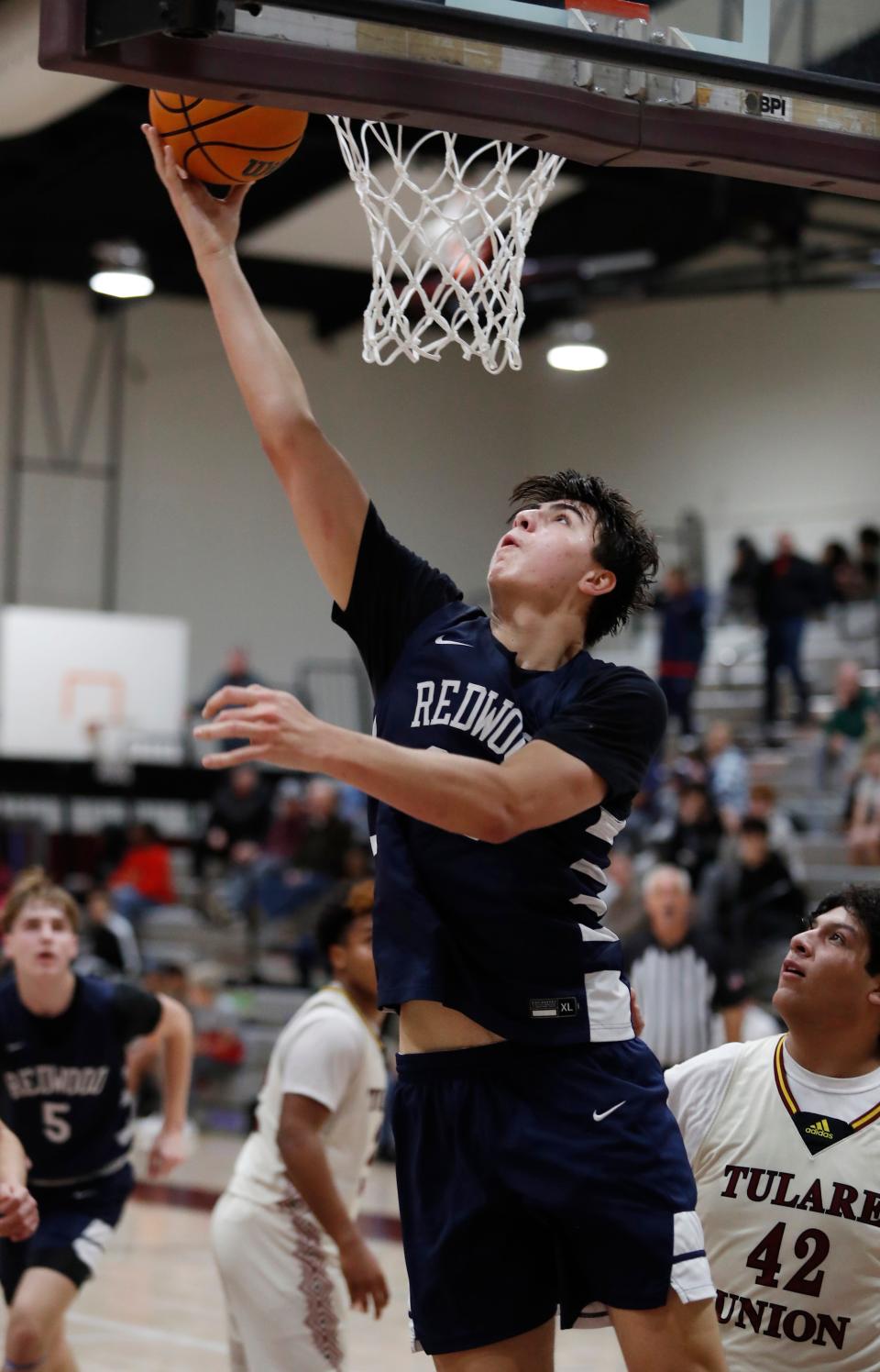 Redwood's Cole Gilcrest lays on in against Tulare Union during their 72nd annual Polly Wilhelmsen Invitational Basketball Tournament championship game in Visalia, Calif., Saturday, Dec. 30, 2023.