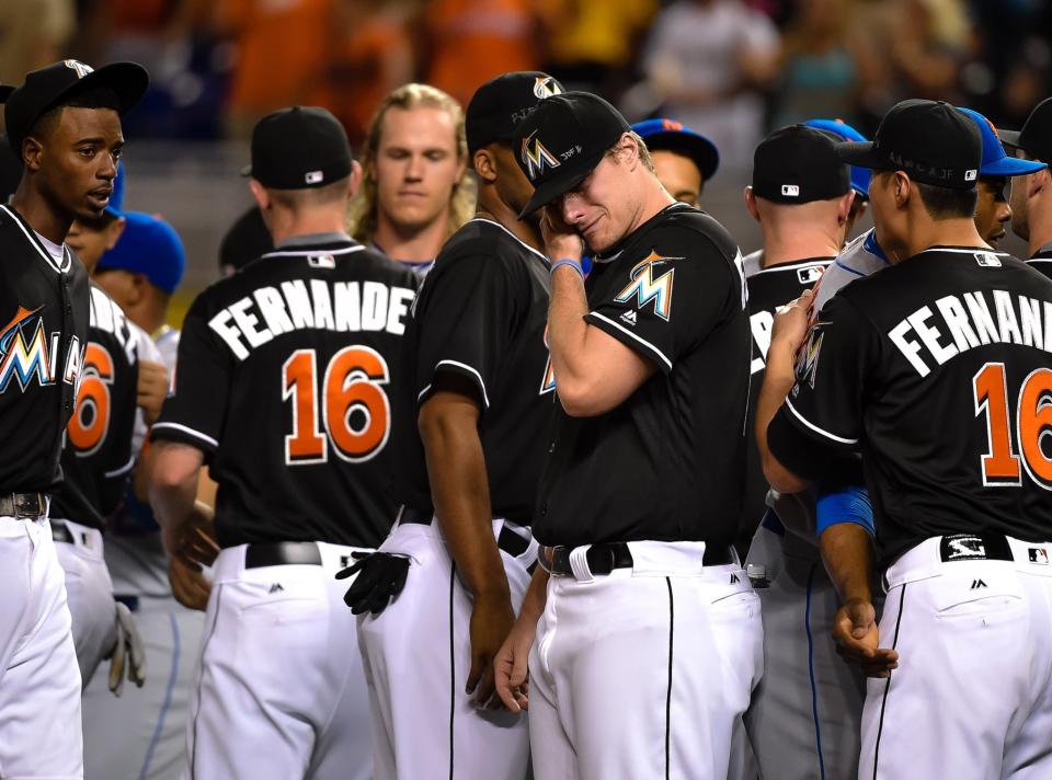 <p>Miami Marlins starting pitcher Tom Koehler (C) wipes tears away after greeting all the New York Mets players at the pitchers mound in honer of Marlins starting pitcher Jose Fernandez who passed away from a boating accident over the weekend at Marlins Park. Mandatory Credit: Steve Mitchell-USA TODAY Sports </p>