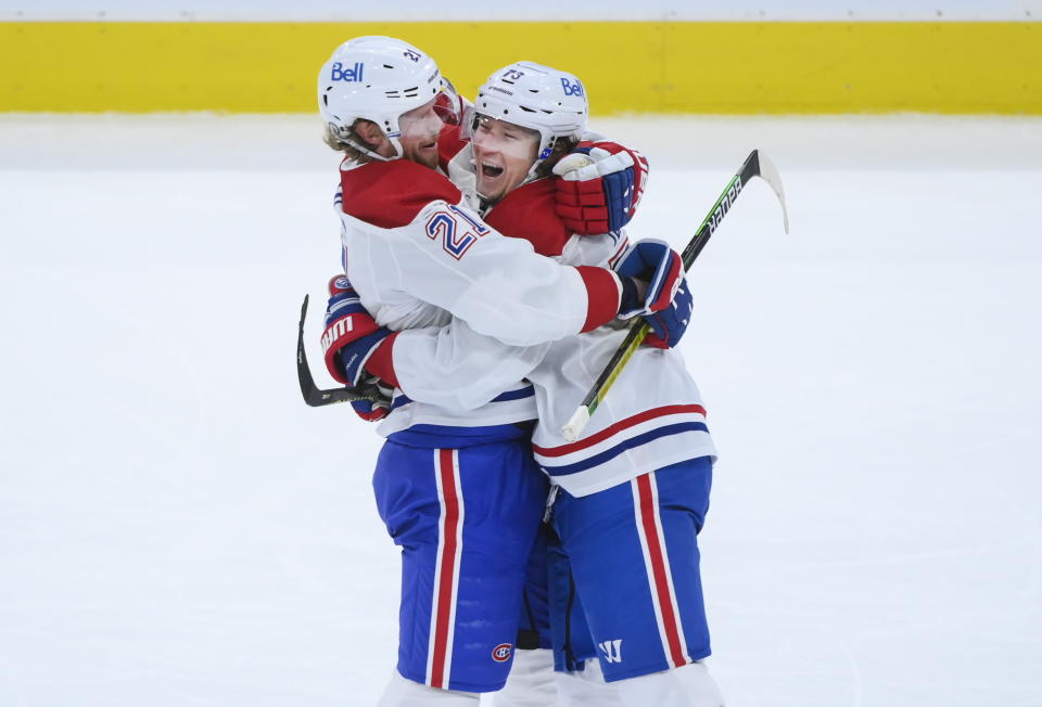 Montreal Canadiens forward Tyler Toffoli (73) celebrates his empty-net goal with teammate Eric Staal (21) during third-period NHL Stanley Cup hockey game action against the Toronto Maple Leafs in Toronto, Monday, May 31, 2021. (Nathan Denette/The Canadian Press via AP)