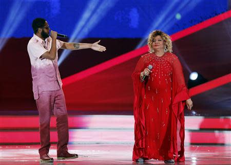 Brazilian singers Alcione (R) and Emicida perform during the draw for the 2014 World Cup at the Costa do Sauipe resort in Sao Joao da Mata, Bahia state, December 6, 2013. REUTERS/Sergio Moraes