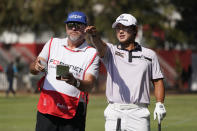 S.H. Kim, right, of South Korea, prepares to hit from off the 18th fairway of the Silverado Resort North Course during the first round of the Fortinet Championship PGA golf tournament in Napa, Calif., Thursday, Sept. 15, 2022. (AP Photo/Eric Risberg)