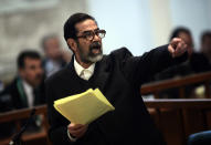 Former Iraqi President Saddam Hussein argues with prosecutors while testifying during cross-examination at his trial in Baghdad's Green Zone April 5, 2006. Hussein returned to court on Wednesday and, in remarks likely to inflame sectarian tensions, immediately accused the Iraqi Interior Ministry of killing and torturing thousands of Iraqis. REUTERS/David Furst/Pool