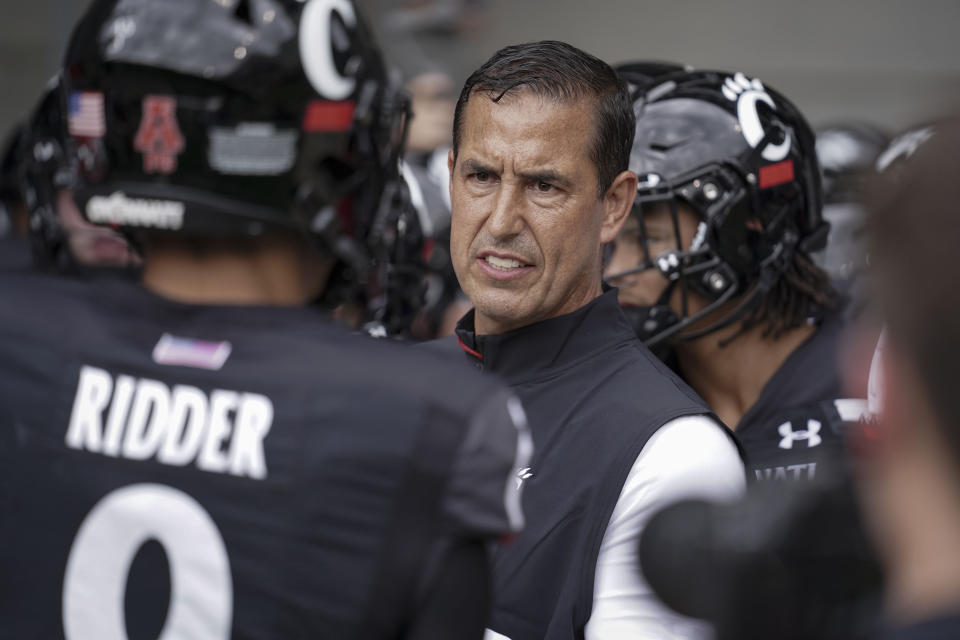 FILE - Cincinnati head coach Luke Fickell speaks with quarterback Desmond Ridder (9) prior to an NCAA college football game against Miami (Ohio) in Cincinnati, in this Saturday, Sept. 4, 2021, file photo. Cincinnati coach Luke Fickell talks about the opportunity the No. 7 Bearcats have to impress the nation when they travel to South Bend, Indiana, to face No. 9 Notre Dame. (AP Photo/Jeff Dean, File)