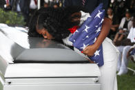 <p>OCT. 21, 2017 – Myeshia Johnson kisses the casket of her husband U.S. Army Sgt. La David Johnson during his burial service at the Memorial Gardens East cemetery in Hollywood, Florida. Sgt. Johnson and three other American soldiers were killed in an ambush in Niger on Oct. 4. (Photo: Joe Raedle/Getty Images) </p>