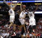 San Diego State forward Josh Davis (22) shoots between Arizona guard Nick Johnson (13), Aaron Gordon (11) and Rondae Hollis-Jefferson (23) during the first half in a regional semifinal of the NCAA men's college basketball tournament, Thursday, March 27, 2014, in Anaheim, Calif. (AP Photo/Jae C. Hong)