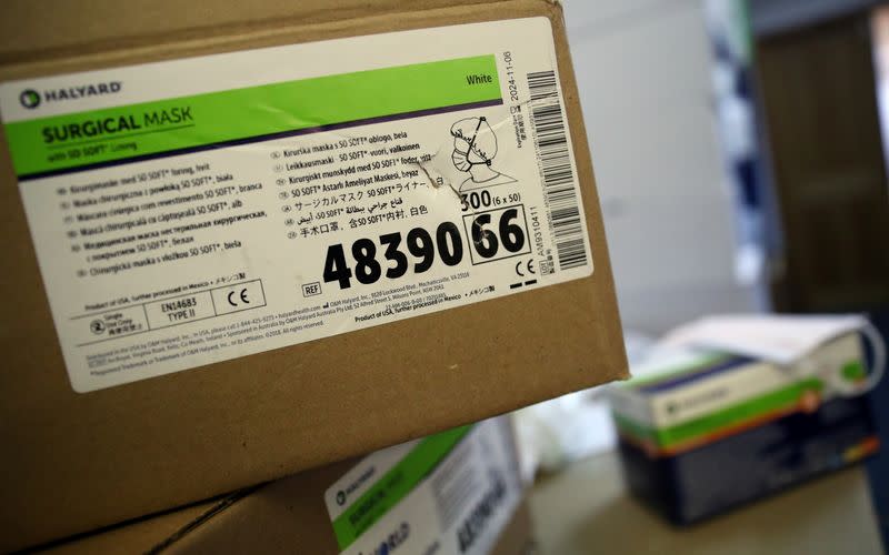 Boxes of protective masks ready for sale are seen in the store room of a medical equipment supply store in south London