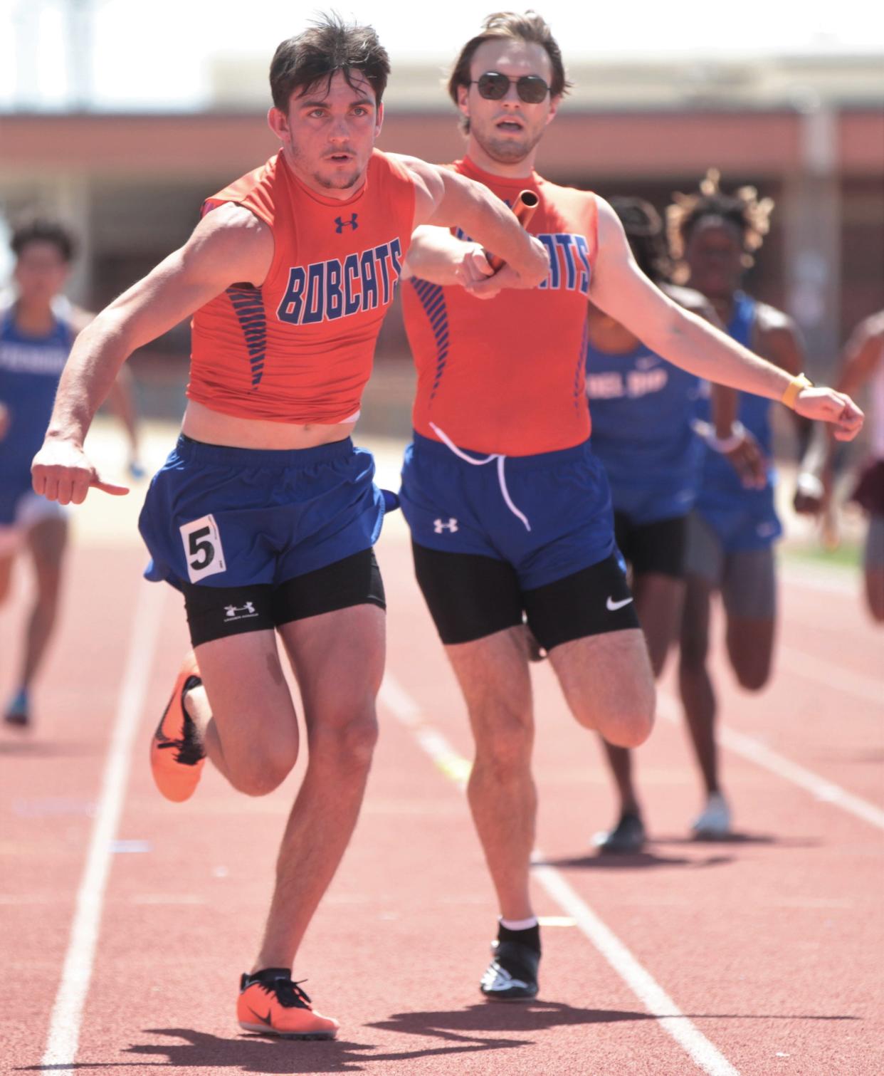 San Angelo Central's Cole McWilliams passes the baton to Tyler Hill during the Division I boys 4x200-meter relay finals at the San Angelo Relays on Saturday, March 26, 2022, at San Angelo Stadium.