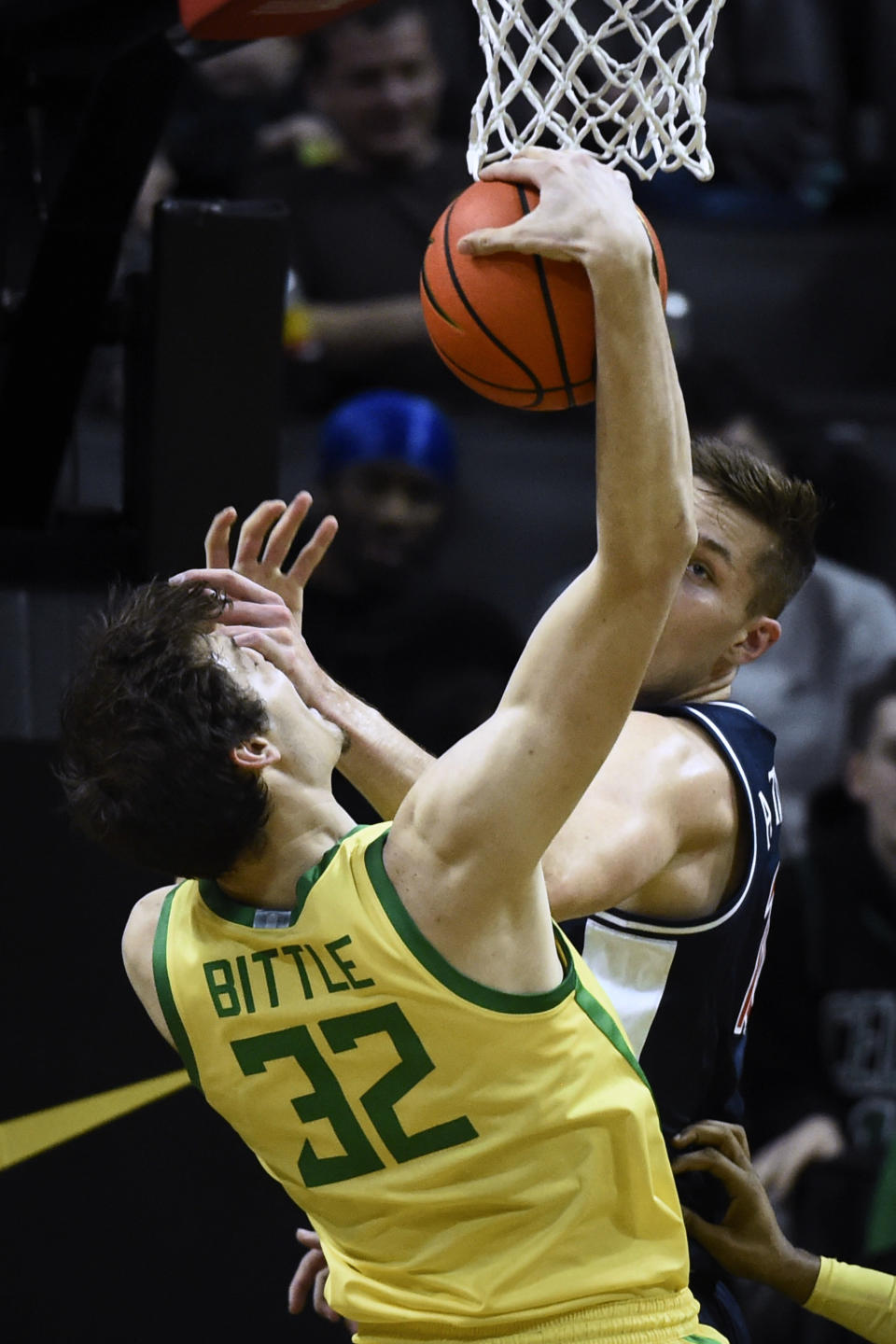 Arizona forward Azuolas Tubelis (10) gets a hand on the face of Oregon center Nate Bittle (32) as they vied for a rebound during the first half of an NCAA college basketball game Saturday, Jan. 14, 2023, in Eugene, Ore. (AP Photo/Andy Nelson)