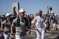 Former San Antonio Spurs guard Tony Parker participates in the torch relay in Marseille, southern France, Thursday, May 9, 2024. Torchbearers are to carry the Olympic flame through the streets of France' s southern port city of Marseille, one day after it arrived on a majestic three-mast ship for the welcoming ceremony. (AP Photo/Laurent Cipriani)