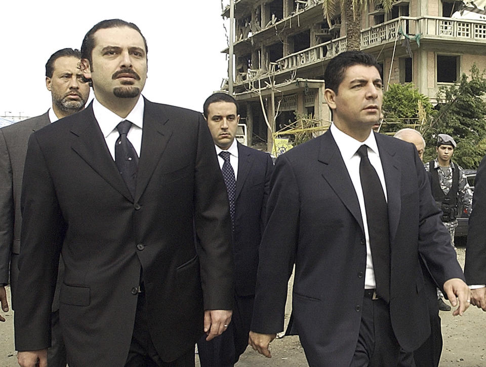 FILE - In this Feb. 19, 2005 file photo, Bahaa Hariri, right, and Saad Hariri, sons of slain Lebanese former Prime Minister Rafik Hariri, visit the scene where their father was assassinated in Beirut, Lebanon. On Sunday, Feb. 20, 2022 Bahaa Hariri said he hopes upcoming elections in the crisis-hit country will bring about a new generation of leaders, saying he will do whatever he can to bring about positive change and accountability for past corruption. His statements came a month after his brother, former Prime Minister Saad Hariri, announced he was bowing out of politics and would not run in parliament elections scheduled for May. (AP Photo, File)