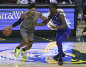 Baylor guard MaCio Teague (31) drives against Kansas guard Marcus Garrett (0) in the first half of an NCAA college basketball game, Monday, Jan. 18, 2021, in Waco, Texas. (AP Photo/Jerry Larson)