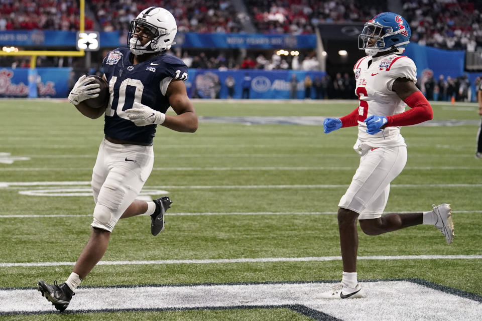 Penn State running back Nicholas Singleton (10) runs into the end zone for a touchdown against Mississippi cornerback Zamari Walton (6) during the second half of the Peach Bowl NCAA college football game, Saturday, Dec. 30, 2023, in Atlanta. (AP Photo/Brynn Anderson)