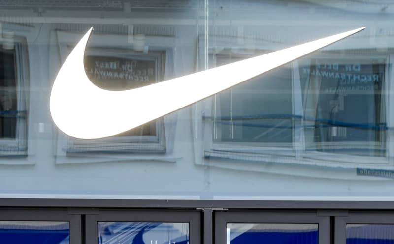 The American athletic footwear Nike's logo seen above the entrance to the department store in downtown Hamburg. Axel Heimken/dpa