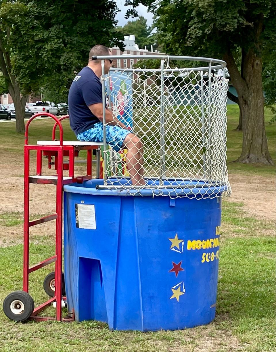 Worcester Police Officer Patrick Bennett mans the dunk tank.