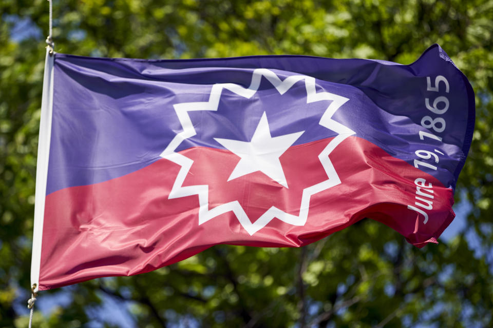 The Juneteenth flag, commemorating the day that slavery ended in the U.S., flies in Omaha, Neb., Wednesday, June 17, 2020. (AP Photo/Nati Harnik)