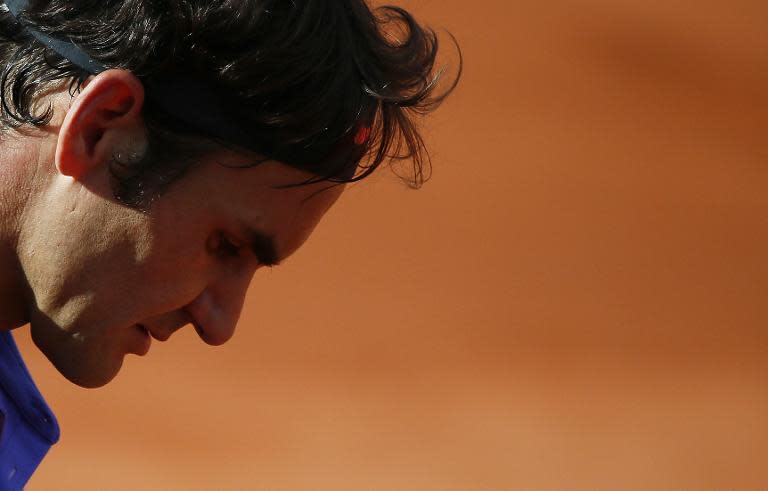 Roger Federer gets ready to serve to Stanislas Wawrinka during their men's quarter final match of the Roland Garros 2015 French Tennis Open in Paris on June 2, 2015