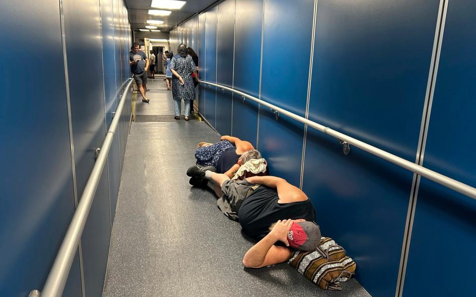 Travelers at Los Angeles International Airport have been forced to sleep in a jetway for a delayed United Airlines flight hit by the IT outage