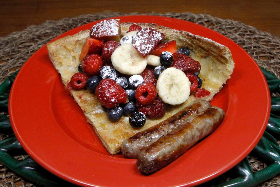 Dutch Baby Pancake can be served with fruit and breakfast sausage on Mother's Day.