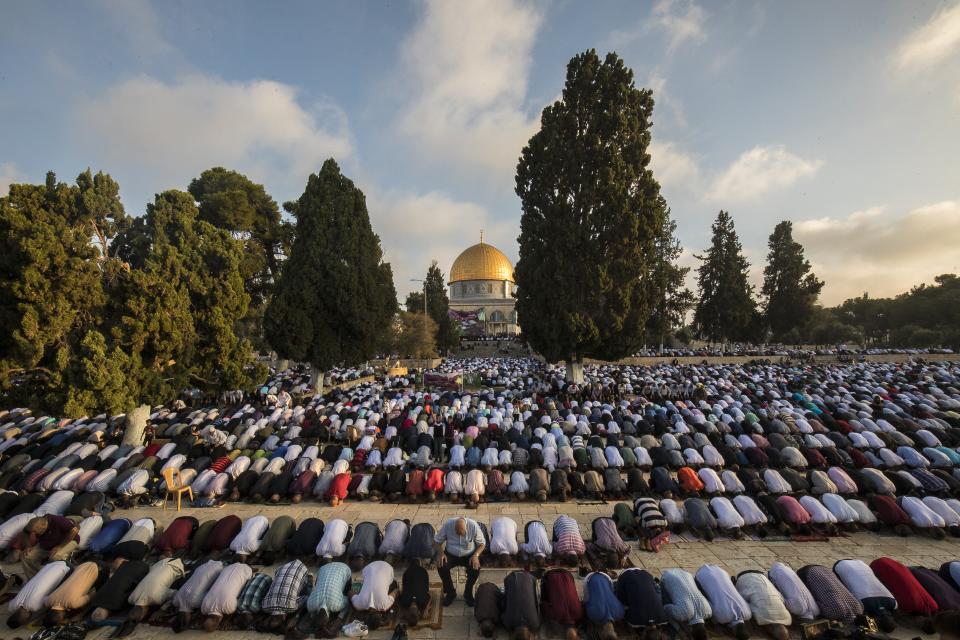 <p>Muslims perform Salat al Eid prayer at the Al-Aqsa mosque compound during the first day of the Eid Al Adha in Jerusalem on August 21, 2018. Muslims worldwide celebrate Eid Al-Adha, to commemorate the holy Prophet Ibrahim’s (Prophet Abraham) readiness to sacrifice his son as a sign of his obedience to God, during which they sacrifice permissible animals, generally goats, sheep, and cows. Eid-al Adha is the one of two most important holidays in the Islamic calendar, with prayers and the ritual sacrifice of animals. (Photo by Mostafa Alkharouf/Anadolu Agency/Getty Images) </p>