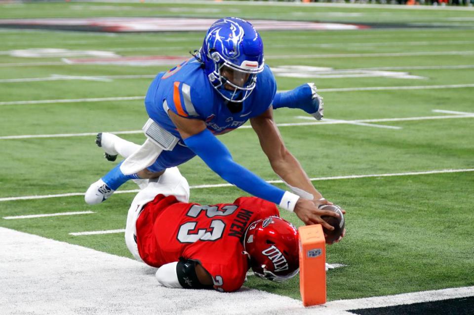 Boise State quarterback Taylen Green (10) dives over UNLV defensive back Quentin Moten (23) for a touchdown during the first half of the Mountain West championship NCAA college football game Saturday at Allegiant Stadium in Las Vegas.