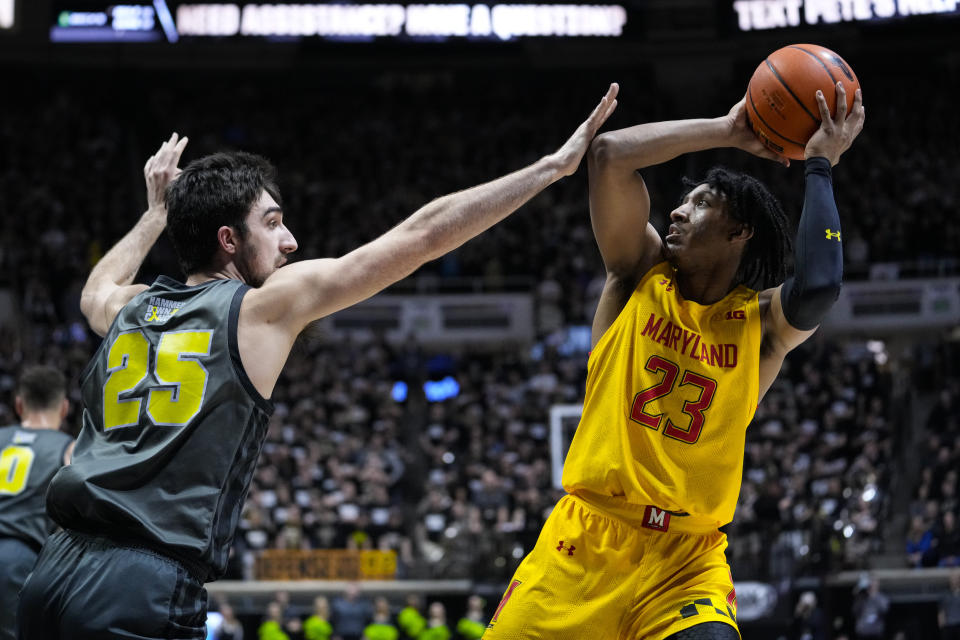 Maryland guard Ian Martinez (23) shoots over Purdue guard Ethan Morton (25) during the first half of an NCAA college basketball game in West Lafayette, Ind., Sunday, Jan. 22, 2023. (AP Photo/Michael Conroy)