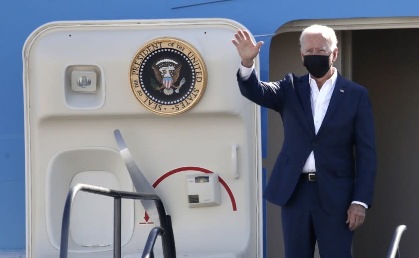 LONG BEACH CA SEPTEMBER 14, 2021 - President Joe Biden waves as he boards Air Force One at Long Beach Airport, Tuesday, Sept. 14, 2021, in Long Beach, Calif. (irfan Khan / Los Angeles Times)