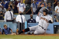 San Francisco Giants' Thairo Estrada scores on a single by LaMonte Wade Jr. during the ninth inning of the team's baseball game against the Los Angeles Dodgers on Thursday, July 22, 2021, in Los Angeles. (AP Photo/Marcio Jose Sanchez)