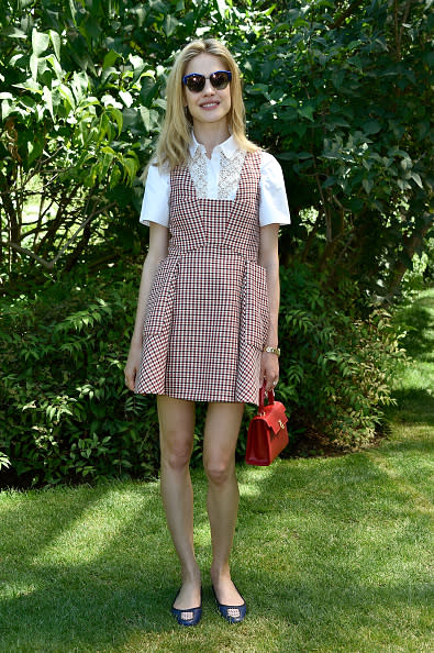 <p>The model, in a red patterned dress with a white collared shirt underneath and flats, dressed just like she could have come straight from the schoolyard.</p>