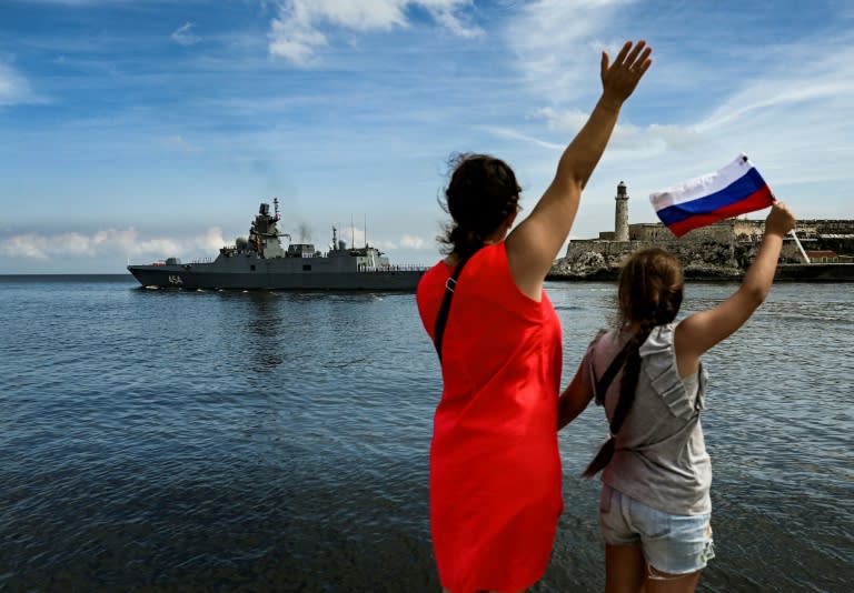 Cubans wave as Russian ships leave the Havana harbor after a five-day visit (YAMIL LAGE)