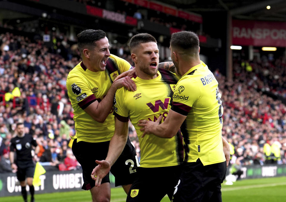 Burnley's Johann Gudmundsson, centre, celebrates with team-mates after scoring their side's fourth goal of the game during the English Premier League soccer match between Burnley FC and Sheffield United at Bramall Lane, Sheffield, England, Saturday April 20, 2024. (Martin Rickett/PA via AP)