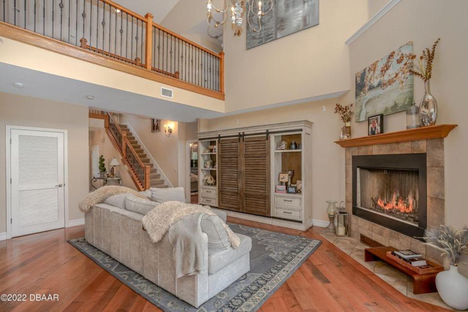 Meander over pecan hardwood flooring and warm yourself by the wood-burning fireplace this gathering room under the loft.