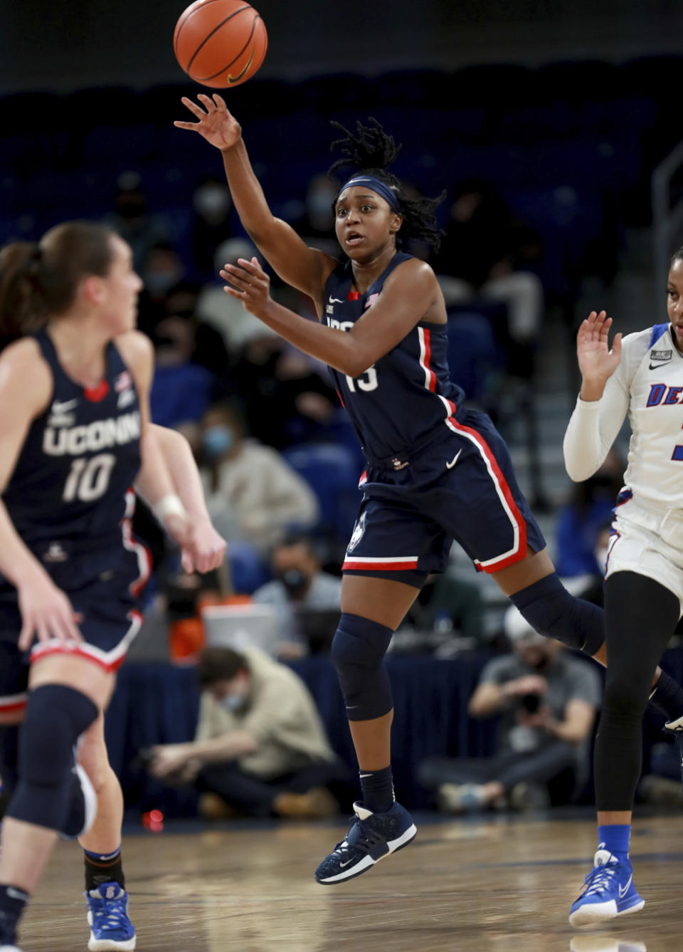 Connecticut guard Christyn Williams (13) makes a pass against DePaul in the first half of an NCAA college basketball game at Wintrust Arena in Chicago on Wednesday, Jan. 26, 2022. (Chris Sweda/Chicago Tribune via AP)