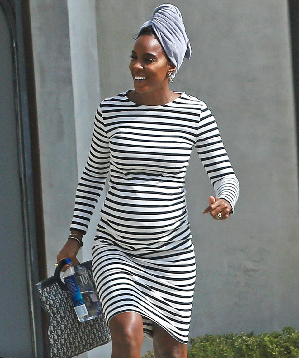 <p>Kelly Rowland shows off her growing baby bump while out visiting a friend on Monday.</p>