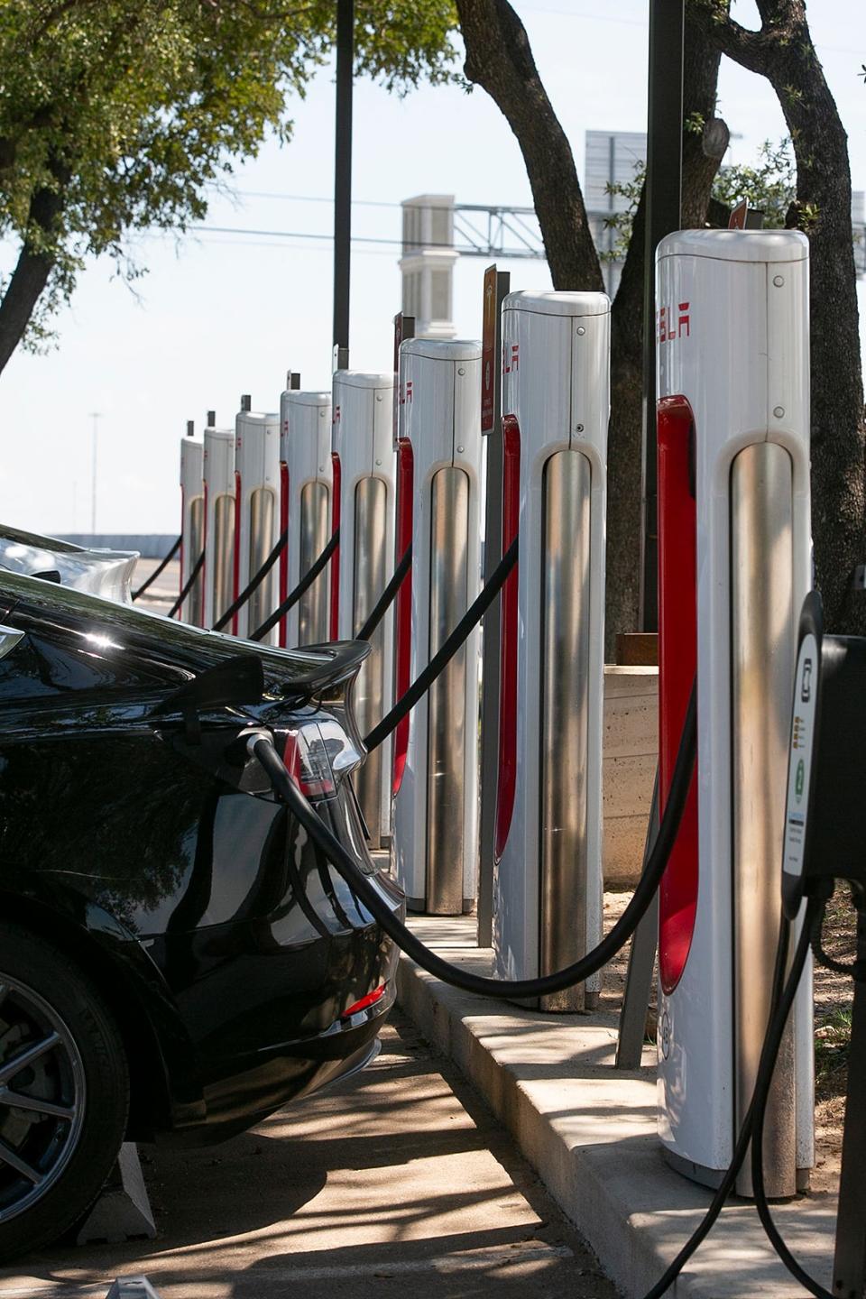 Electric vehicles charge at the Tesla supercharger station in Austin, Texas on Friday, July 1, 2022.