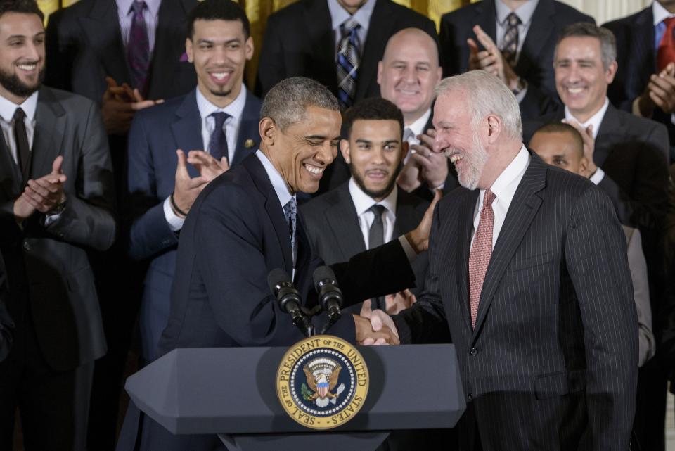 Then-President Barack Obama shares a laugh with San Antonia Spurs coach Gregg Popovich when the team visited the White House in 2015 to celebrate its 2014 NBA title. (Photo: BRENDAN SMIALOWSKI via Getty Images)